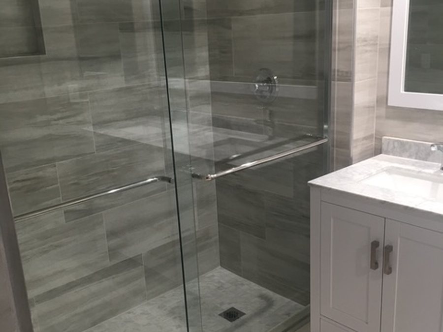 Bathroom after remodel with new walk-in glass shower and vanity