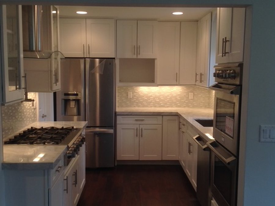 Modern kitchen remodel with tile backsplash and new fixtures by Fontana Plumbing