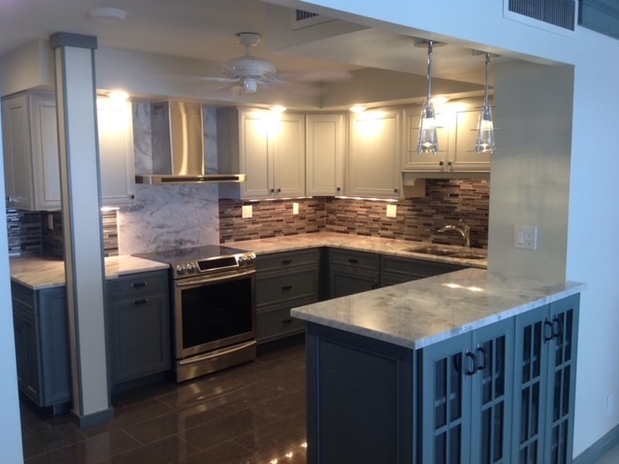 Kitchen remodel with navy island and stone counters by Fontana Plumbing