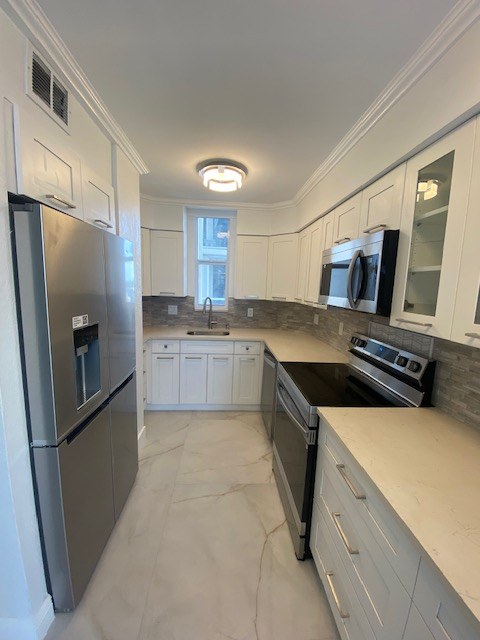 Modern white kitchen remodel with island and new plumbing by Fontana Plumbing